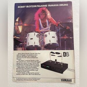 Yamaha White Drum Kit Pinup of Ratt’s Bobby Blotzer with Purple-Pink Stage
